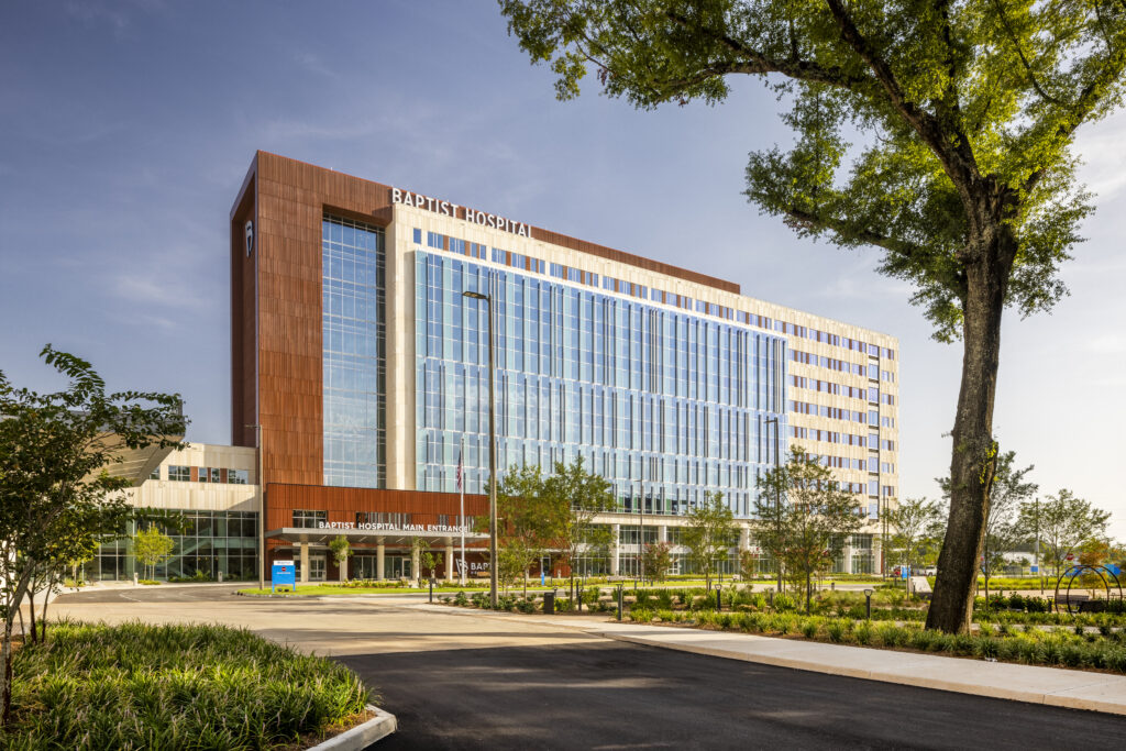 Baptist Hospital exterior, featuring a large building with brick and tall windows across the front.